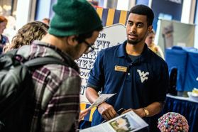 WVU staff member works with student at housing fair