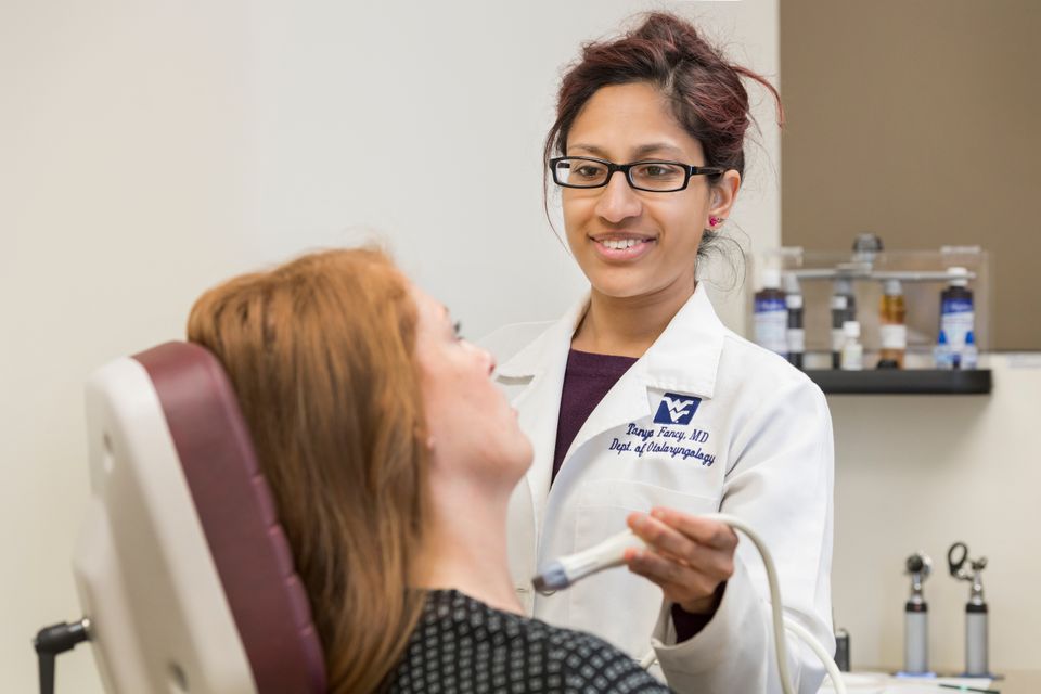 WVU physician works with patient